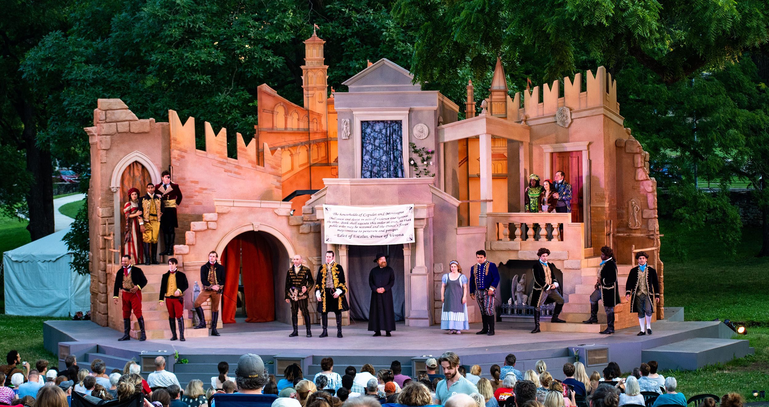Large crowd enjoys an outdoor Shakespeare performance