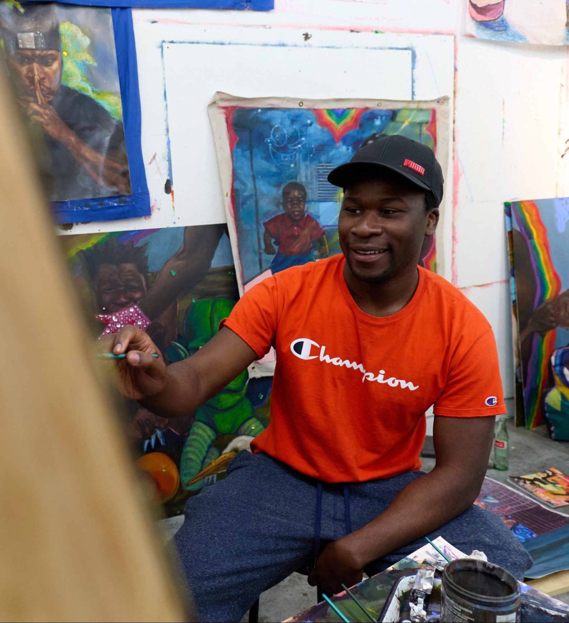 Man paints on a canvas in his art studio